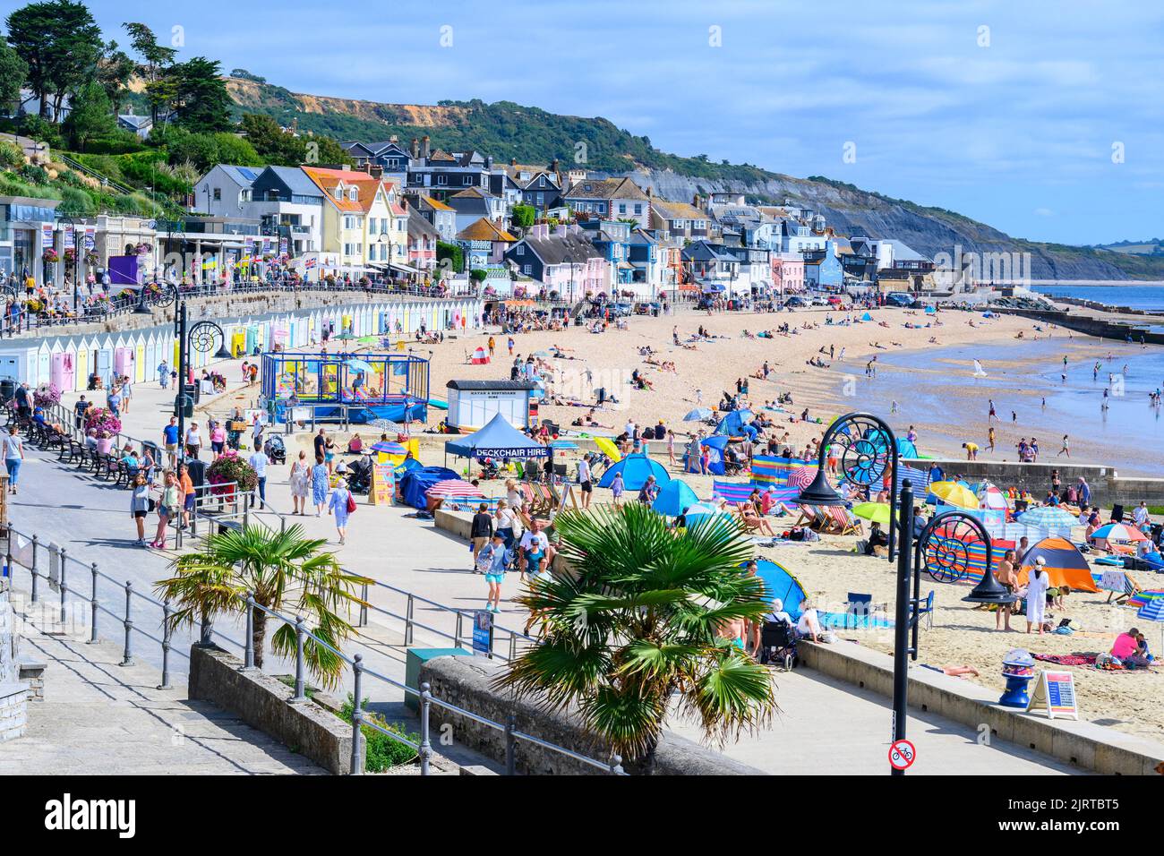 Lyme Regis, Dorset, UK. 26th Aug, 2022. UK Weather: Holidays and sunbathers flock to the busy beach at the seaside resort of Lyme Regis to bask in scorching hot sunshine as the summery weather returns in time for the August Bank Holiday Weekend. Credit: Celia McMahon/Alamy Live News Stock Photo