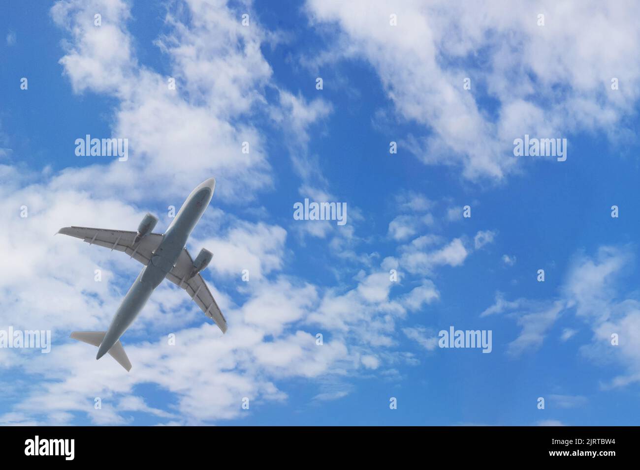 Flying plane in blue sky with clouds on white background Stock Photo ...