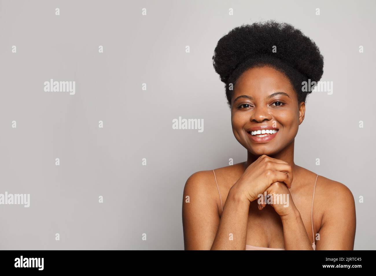 Cheerful young adult woman smiling and looking at camera Stock Photo ...