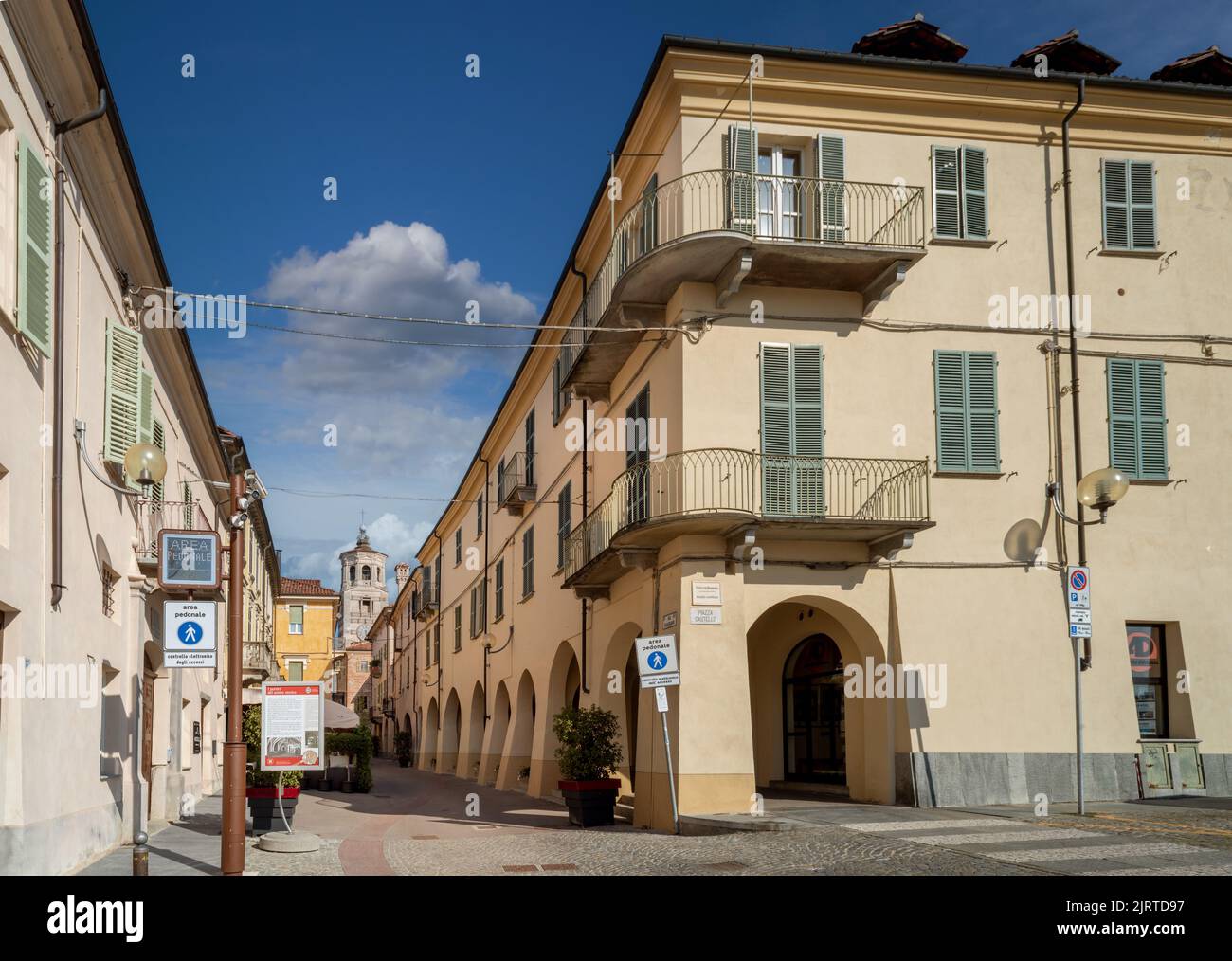 Fossano, Cuneo, Italy - August 25, 2022: the historic center with via Cavour, pedestrian street with arcades and the civic bell tower at the bottom, b Stock Photo