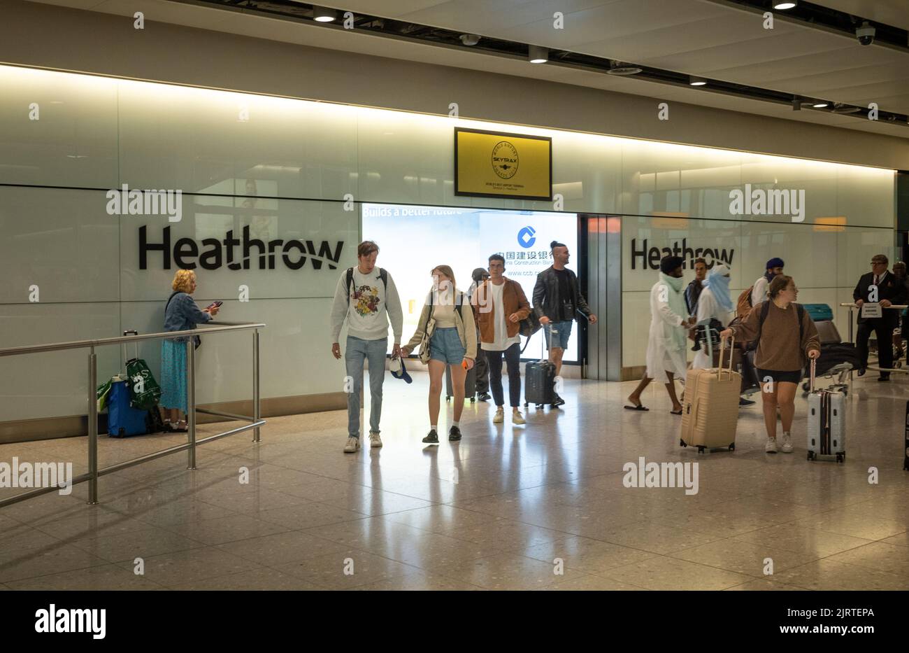 International passengers arrive at London Heathrow Airport, Terminal Two. Stock Photo
