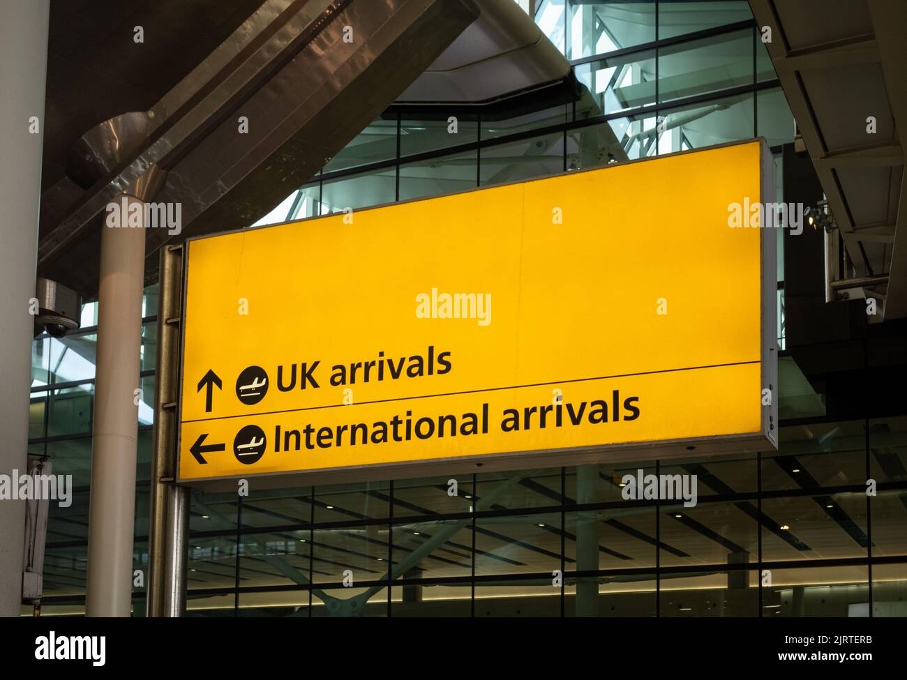 A large sign pointing out directions for UK and international arrivals at London Heathrow Airport, Terminal Two. Stock Photo
