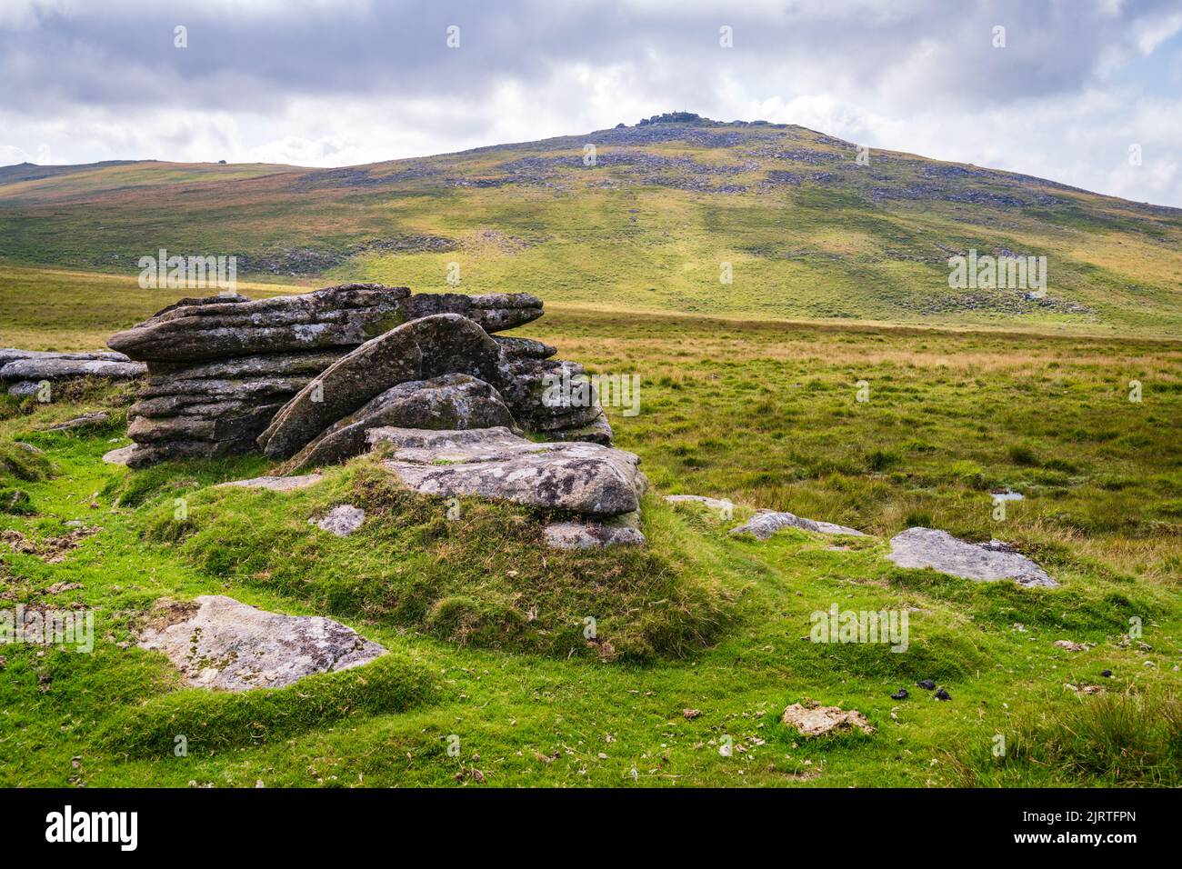 Detail of granite outcropping on West Mill Tor with Yes Tor in the distance.  Dartmoor National Park, Devon, UK. Stock Photo