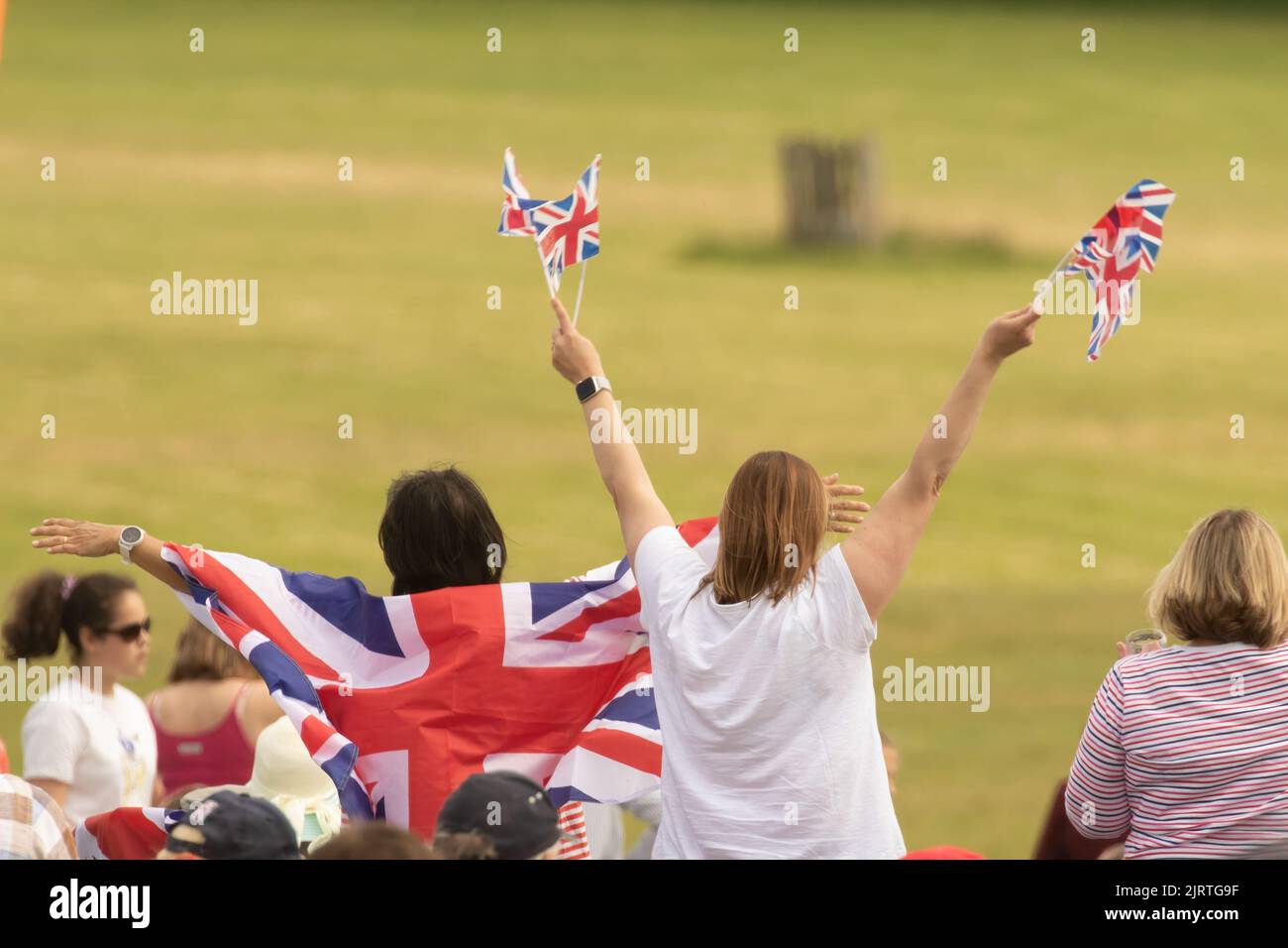 people celebrating being British with Union Jack flags Stock Photo