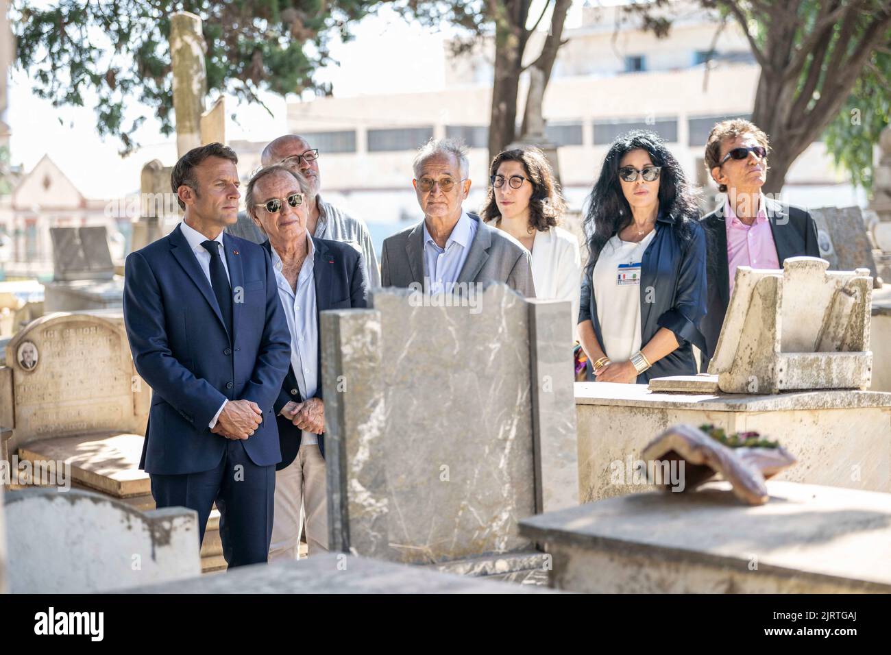 Algiers, Algeria, August 26, 2022, French President Emmanuel Macron , French film director Alexandre Arcady French economist Jacques Attali , and French Culture Minister Rima Abdul-Malak visit the grave of French actor Roger Hanin at the European Saint-Eugene Cemetery in Algiers accompanied by the caretaker of the cemetery on August 26, 2022. Photo by Eliot Blondet/ABACAPRESS.COM Stock Photo