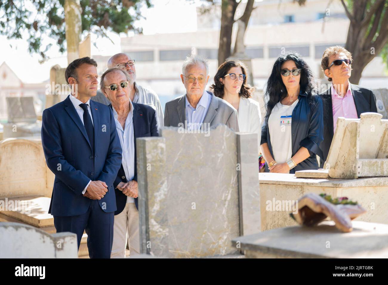 Algiers, Algeria, August 26, 2022, French President Emmanuel Macron , French film director Alexandre Arcady French economist Jacques Attali , and French Culture Minister Rima Abdul-Malak visit the grave of French actor Roger Hanin at the European Saint-Eugene Cemetery in Algiers accompanied by the caretaker of the cemetery on August 26, 2022. Photo by Eliot Blondet/ABACAPRESS.COM Stock Photo