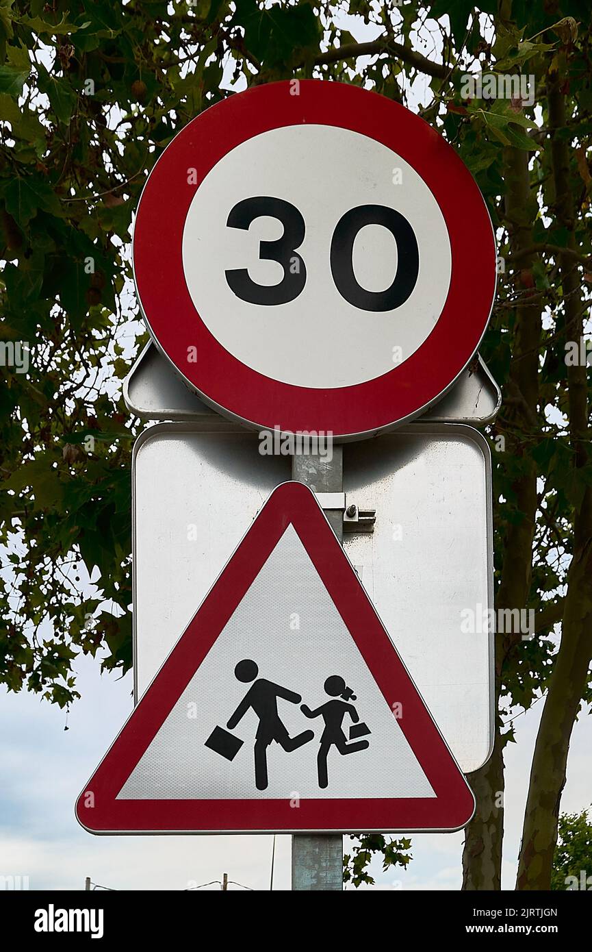 School zone danger sign and speed limit traffic sign 30 Stock Photo