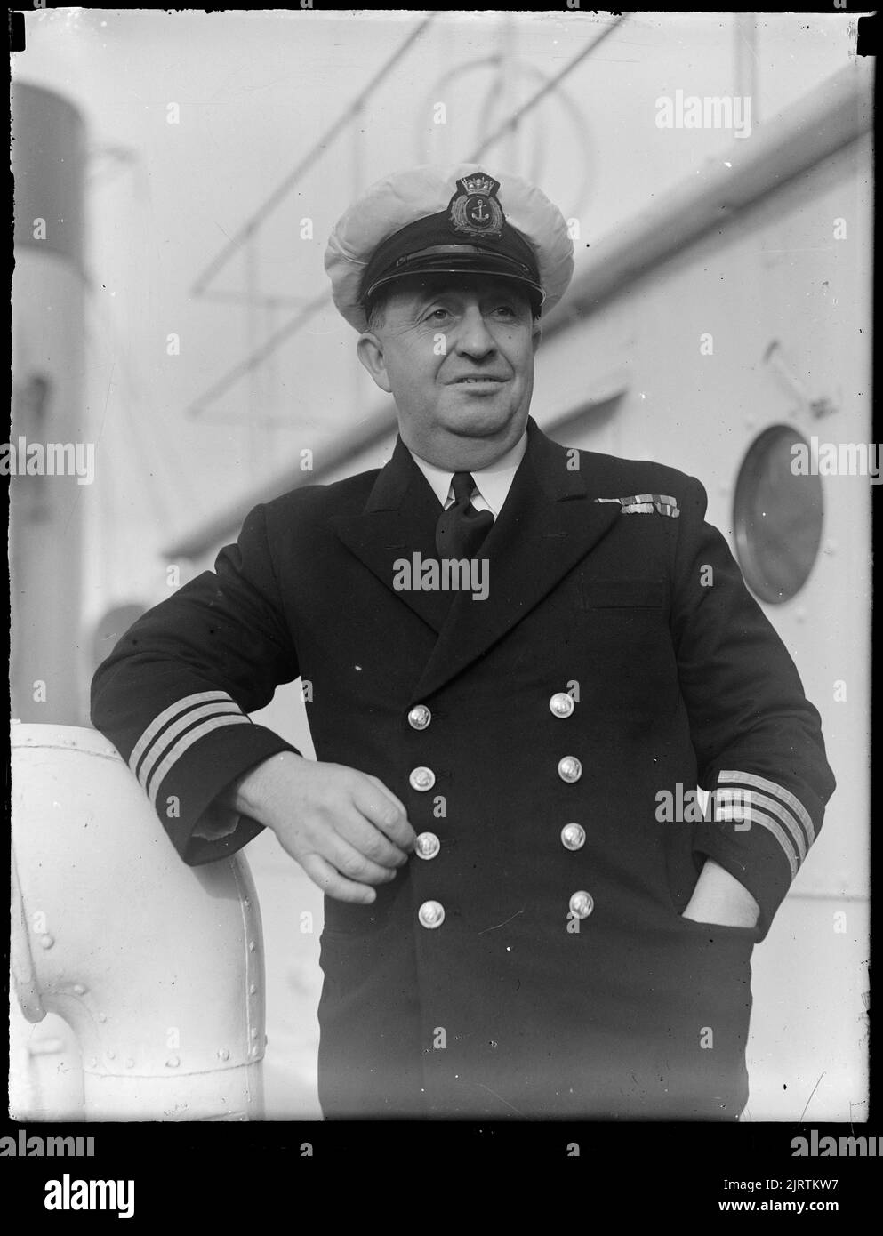 Man in naval uniform, aboard ship, by Leslie Adkin Stock Photo Alamy