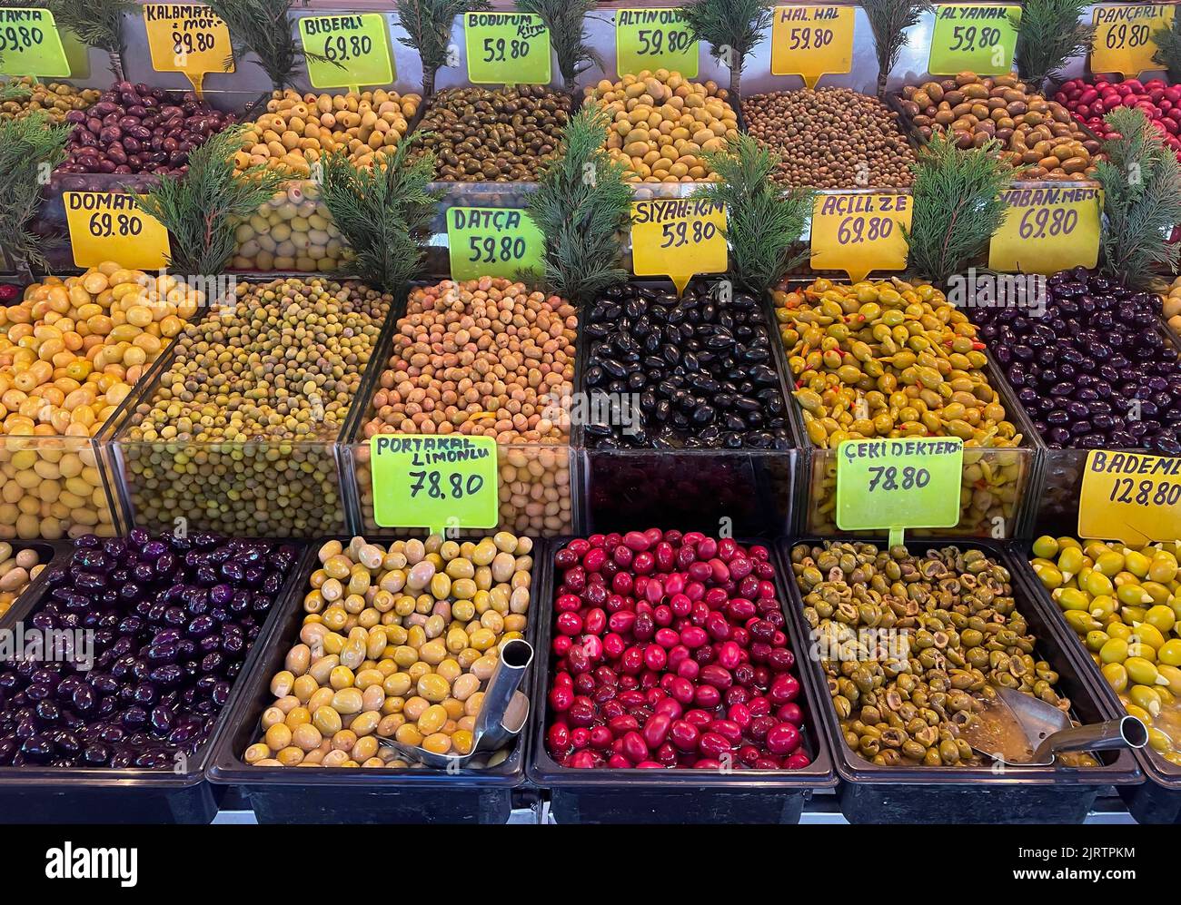 Various olives for sale at a market stall, Assorted multicolored olives