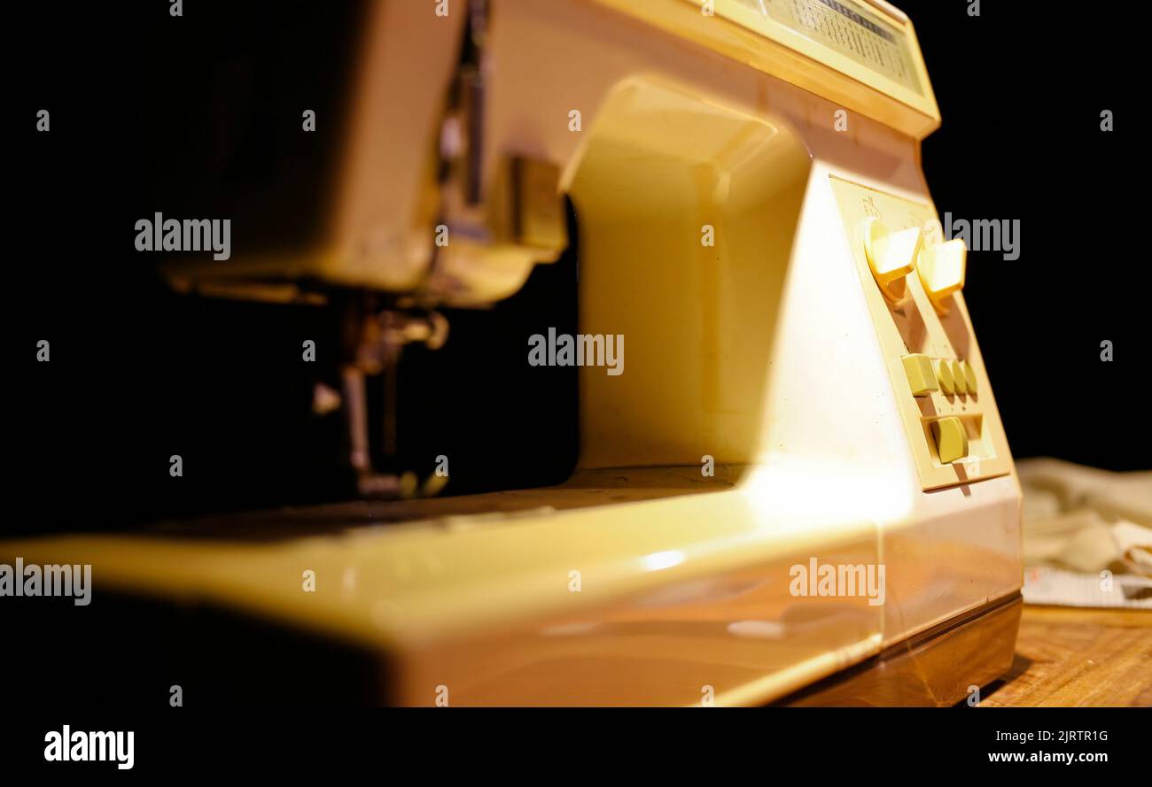 Sewing machine on table in tailor's Stock Photo Alamy