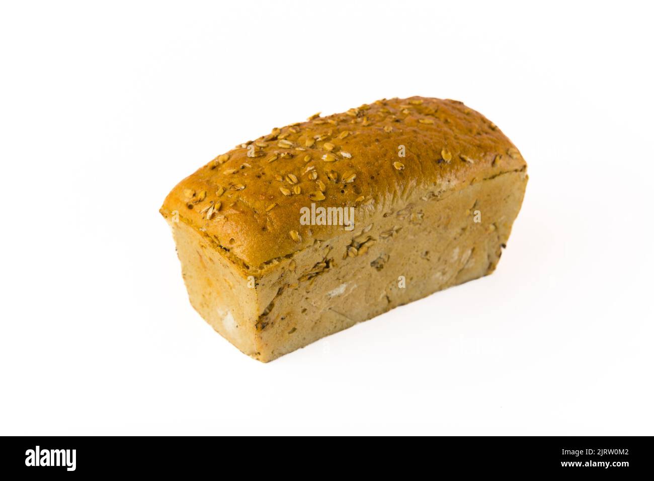 Bakery concept. New product baked by a professional baker. Whole wheat loaf of bread with oats isolated on white background. High quality photo Stock Photo
