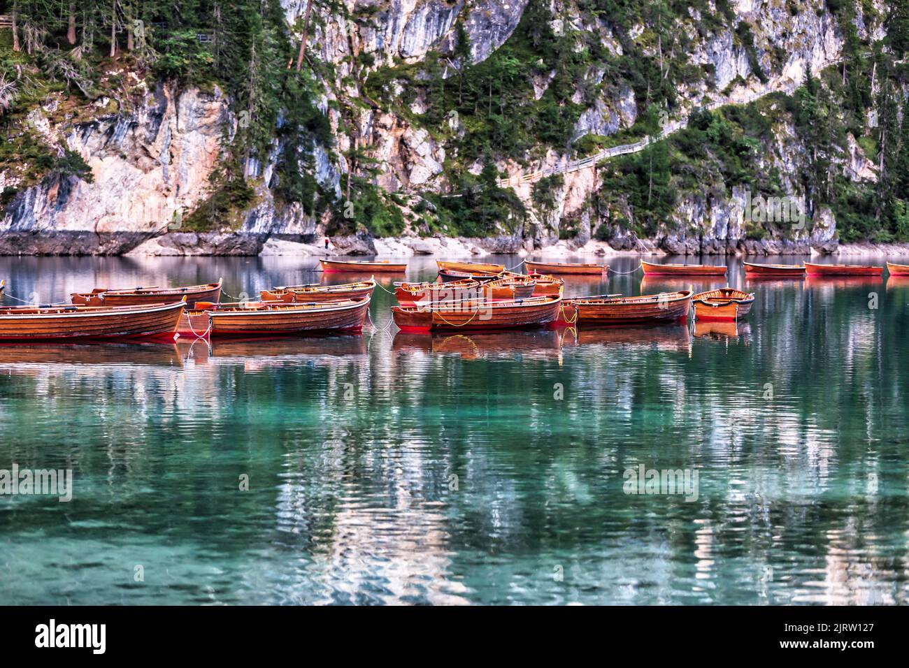 quaint and picturesque wooden boats in a lake in the mountains Stock Photo