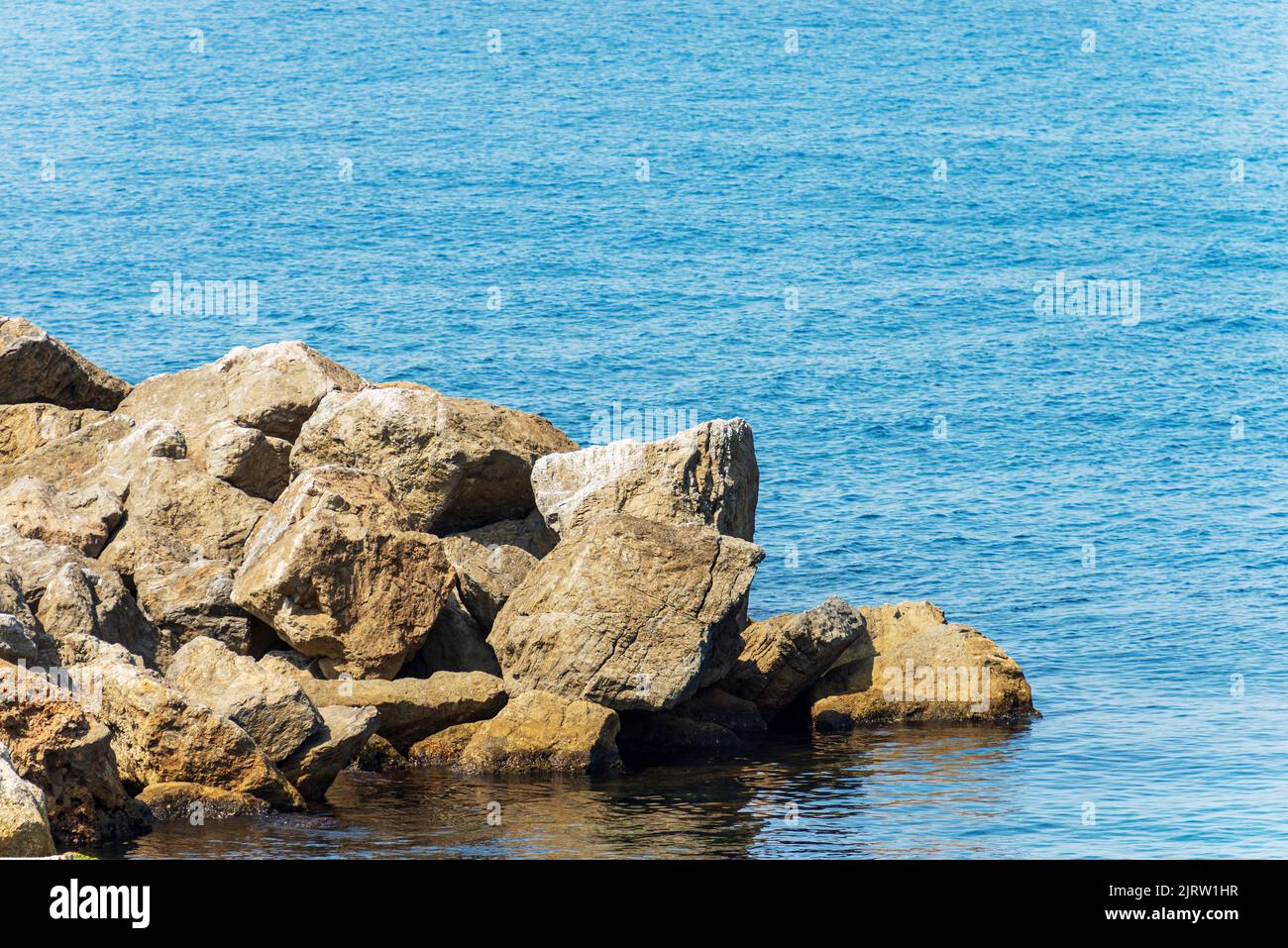 Popular Rocks Italy Breakwater or groyne made of giant boulders by the sea, Port of the ...