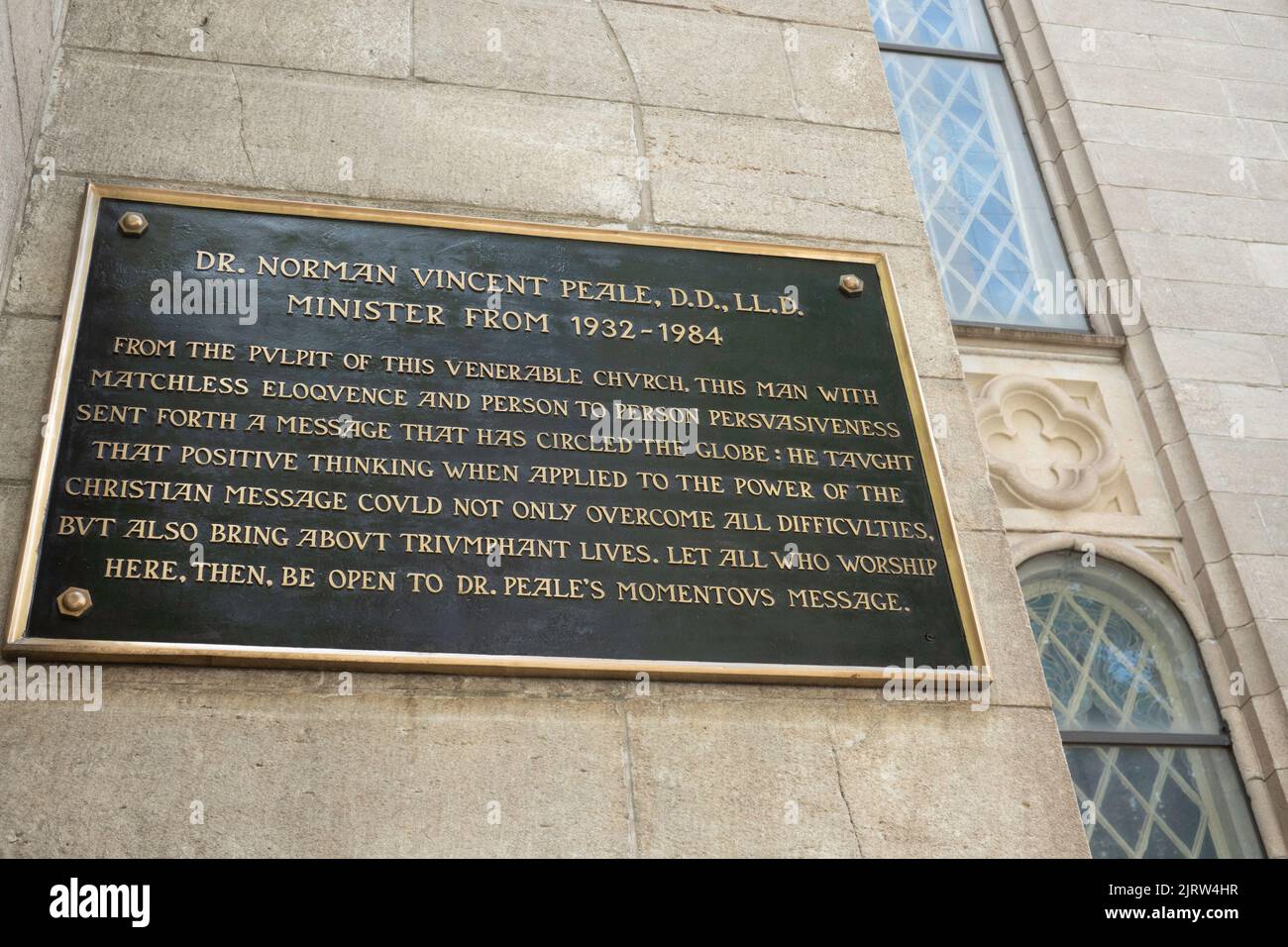 A plaque honoring Dr. Norman Vincent Peale in front of the Marble Collegiate Church of Fifth Avenue in New York City, USA  2022 Stock Photo