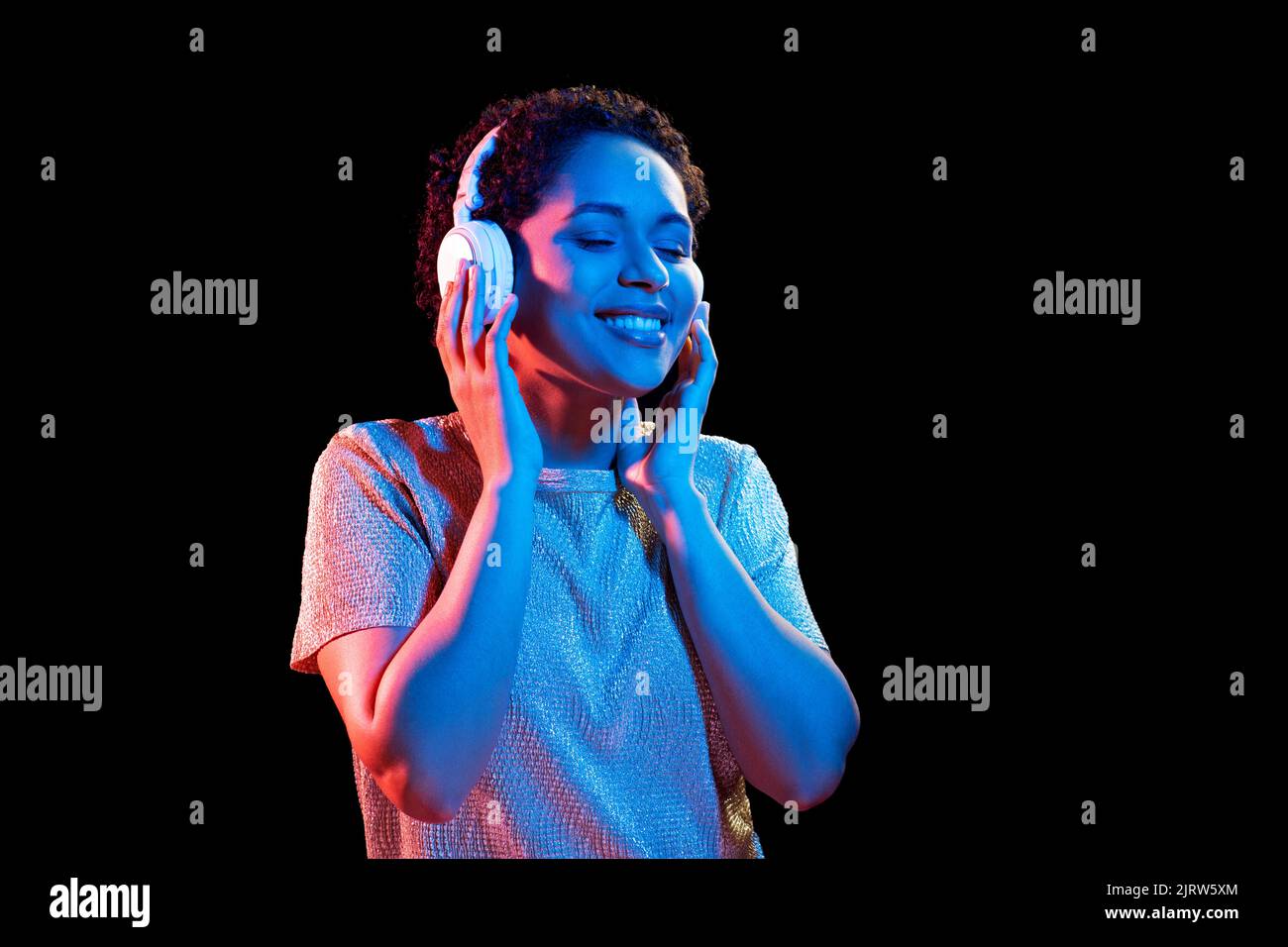 woman in headphones listening to music and dancing Stock Photo - Alamy