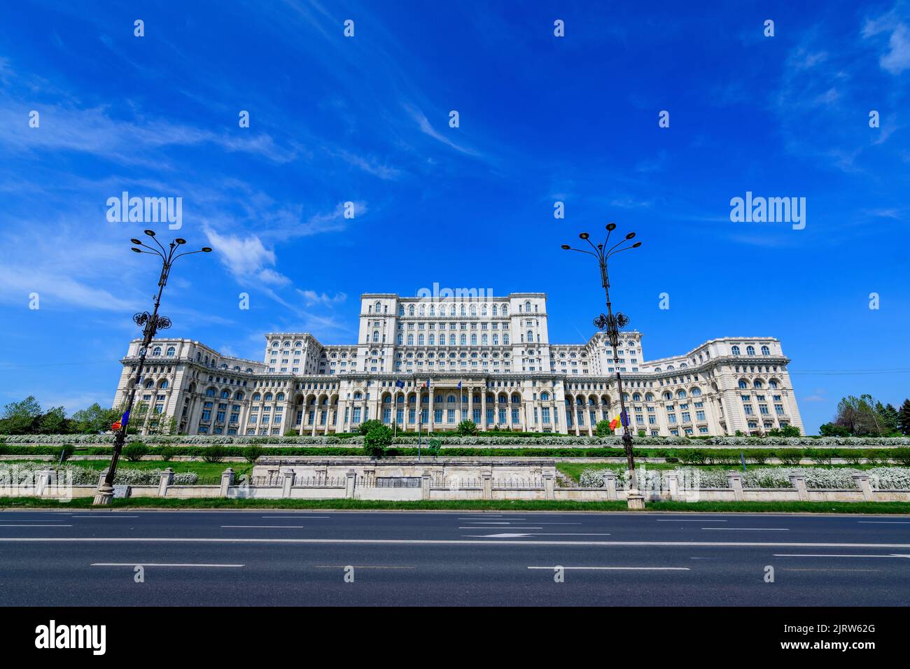 The Palace of the Parliament also known as People's House (Casa Popoprului) in Constitutiei Square (Piata Constitutiei) in Bucharest, Romania, in a su Stock Photo