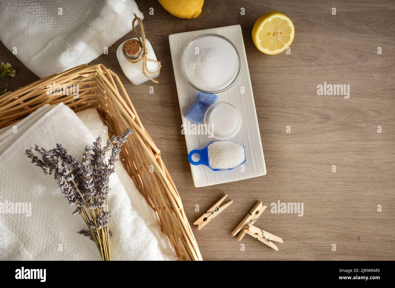 Clothes washing concept with towels and products on wooden table. Top view. Horizontal composition. Stock Photo