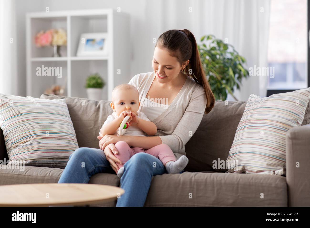 mother and little baby with teething toy at home Stock Photo