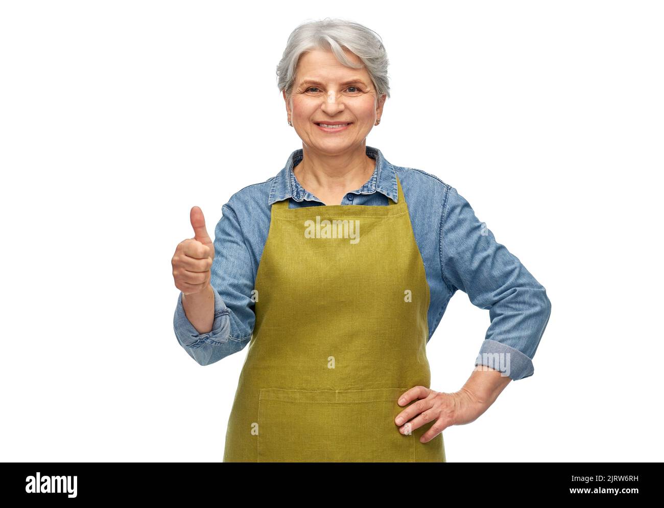 senior woman in garden apron showing thumbs up Stock Photo - Alamy