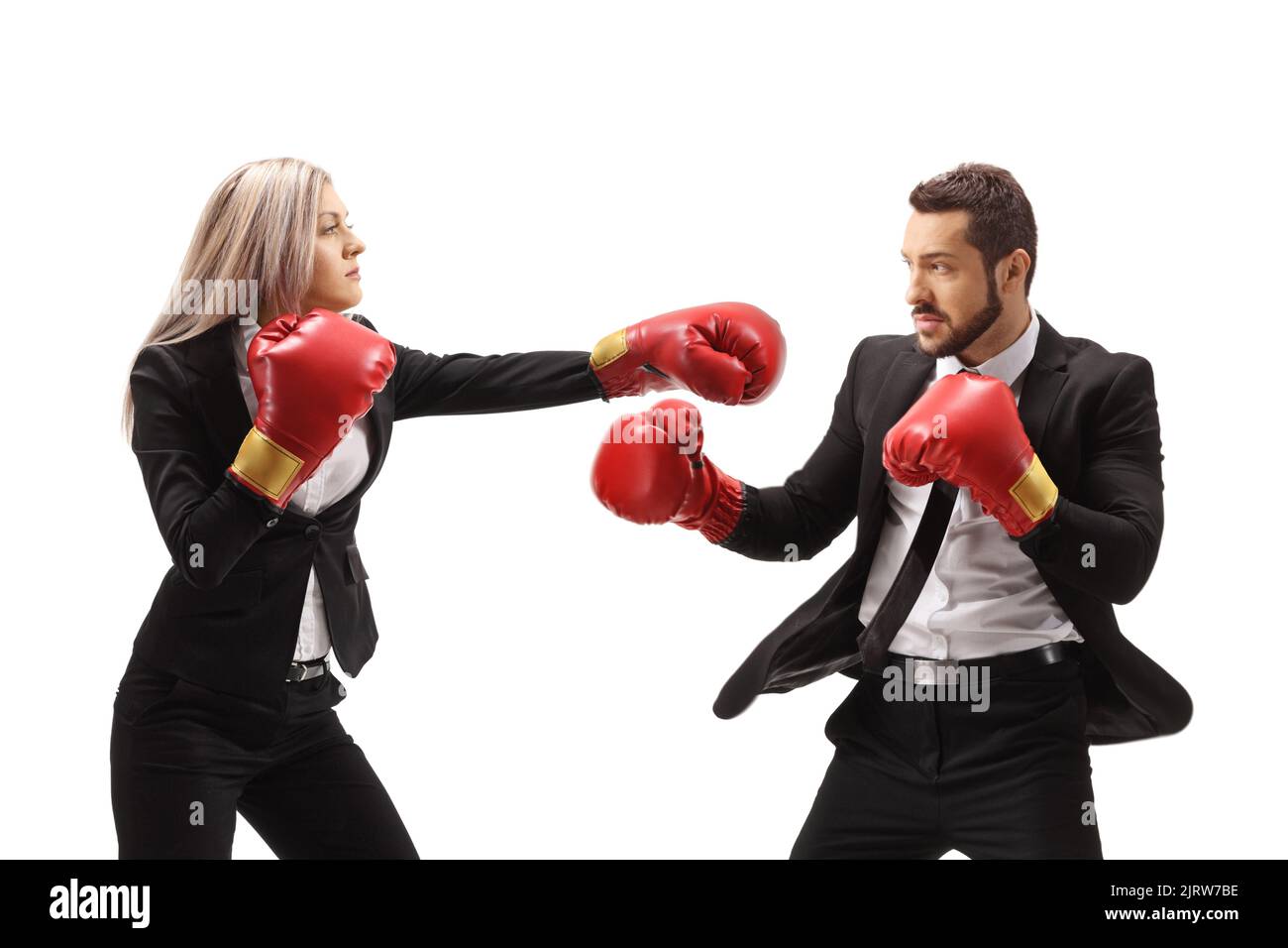 Young businesswoman hitting a businessman with boxing gloves isolated on white background Stock Photo