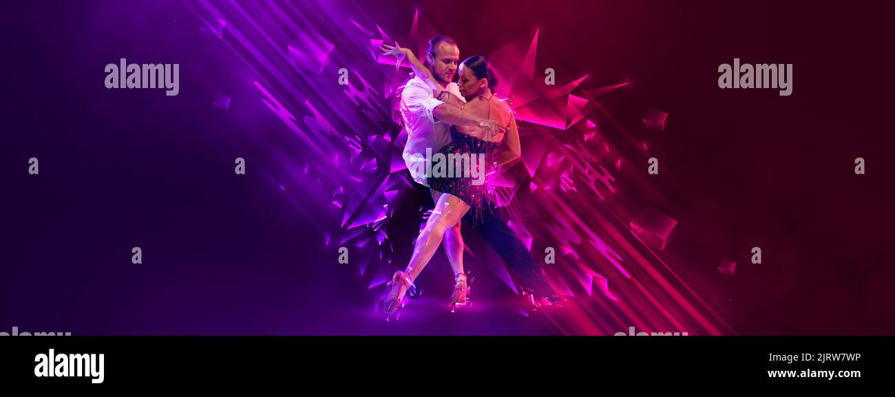 Elegant young couple of dancers dancing samba, cha-cha-cha, rumba, paso doble over dark background with neon fluid elements. Art, beauty, dance Stock Photo