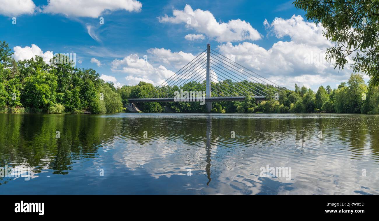 Beautiful scenery with road cable-stayed bridge over Jordan pond in Czech Tabor city. Closeup a shiny rippled water surface in scenic summer landscape. Stock Photo