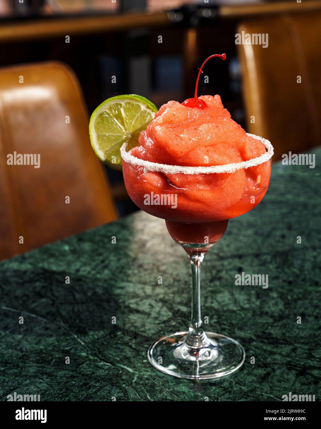 A strawberry frappe drink with lime slice served at the cafe Stock