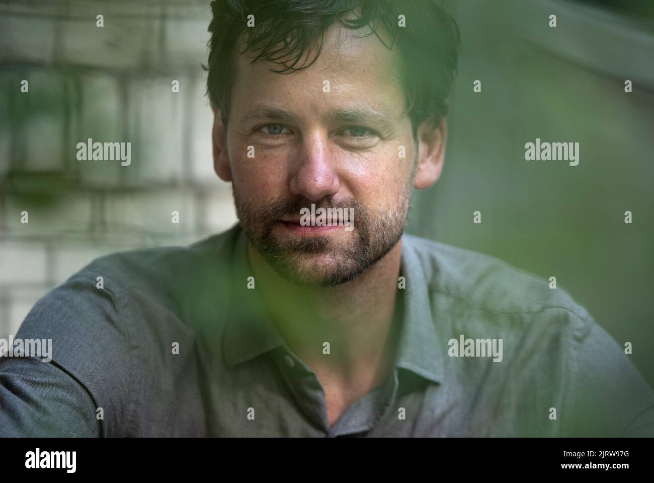 Berlin, Germany. 26th Aug, 2022. Actor Florian Stetter sits on a bench