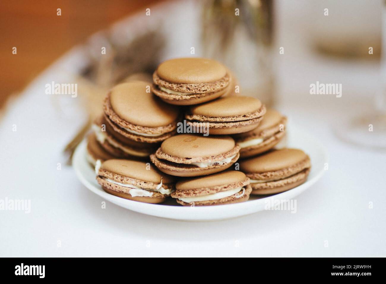 A mountain of macaroons in a plate on a wedding table. Stock Photo