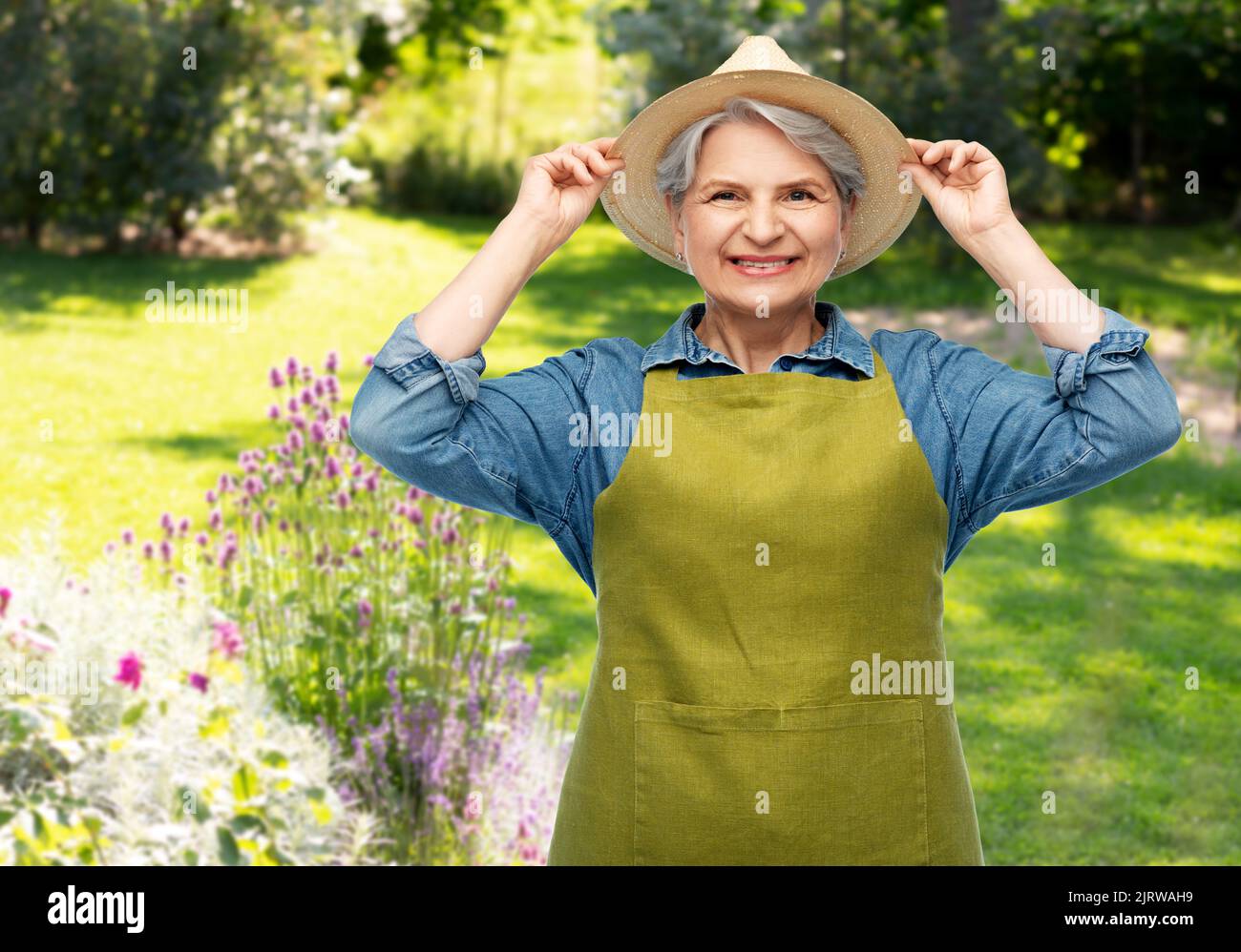 portrait of smiling senior woman in garden apron Stock Photo - Alamy