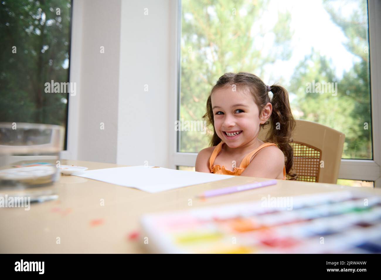 Caucasian adorable funny little girl smiles, looking at the camera ...