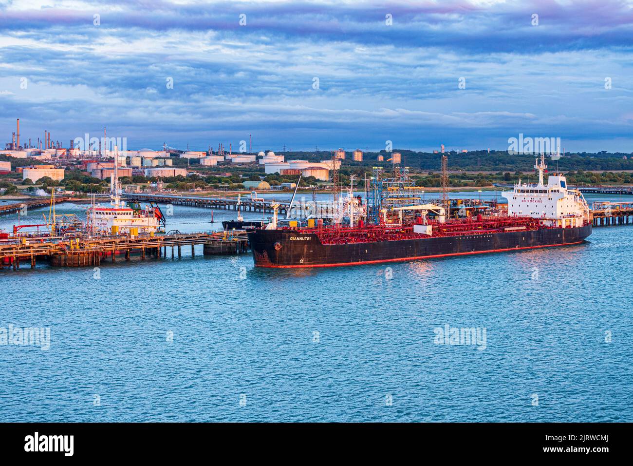 The chemical/oil products tanker Giannutri at dawn moored at the Esso owned Fawley Oil Refinery at Fawley, Hampshire UK Stock Photo