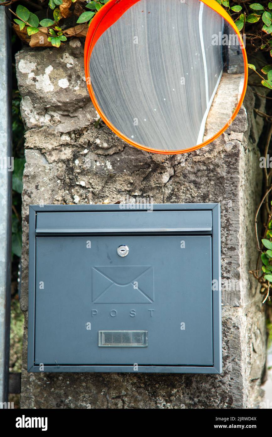 Mailboxes post mounted at entry gates, mailboxes embedded in a stone