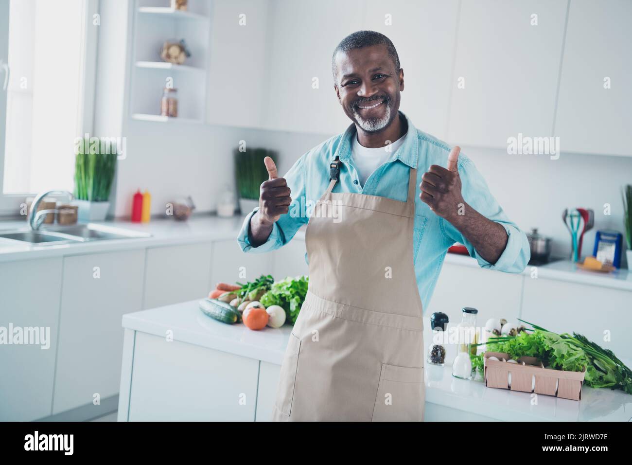Photo of cheerful positive age man wear apron cooking lunch showing