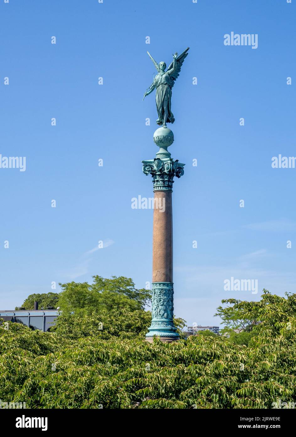 Bronze statue of Winged Victory by Ferdinand Edvard Ring crowning the Ivar Huitfeldt Column at Langelinie in Copenhagen Denmark Stock Photo