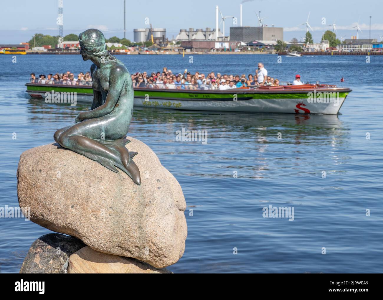 Tourists in Copenhagen Denmark visiting the bronze sculpture of the Little Mermaid by Edvard Eriksen on the Langelinie promenade by the city's harbour Stock Photo