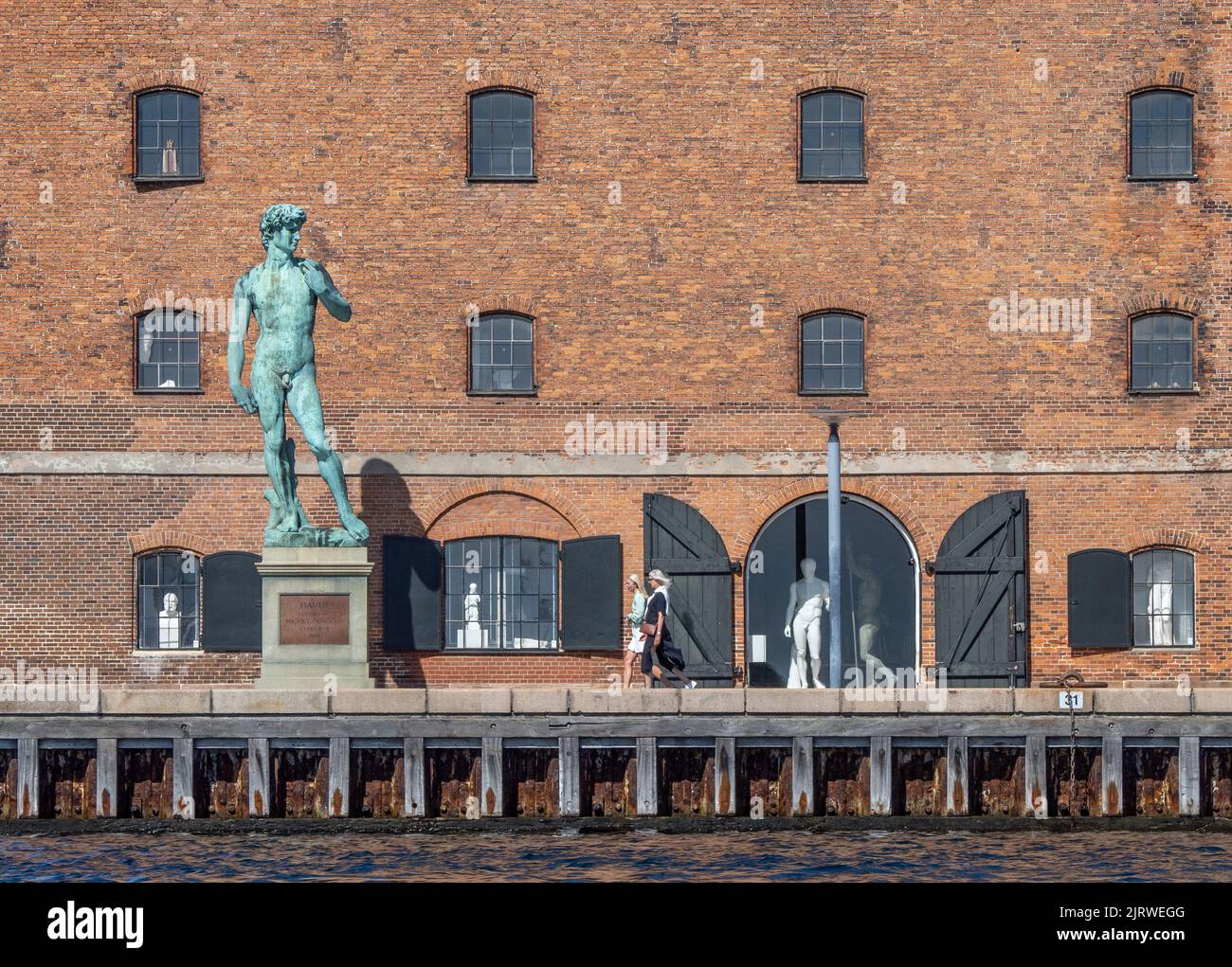 Cast of Michelangelo's David outside the Royal Cast Collection museum in the old Vestindisk Pakhus warehouse by Copenhagen's harbour - Denmark Stock Photo