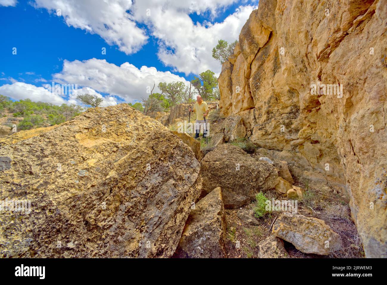 A hiker making his way down the side of a cliff along Coronado Ridge at Grand Canyon Arizona. Located near Coronado Butte. Stock Photo