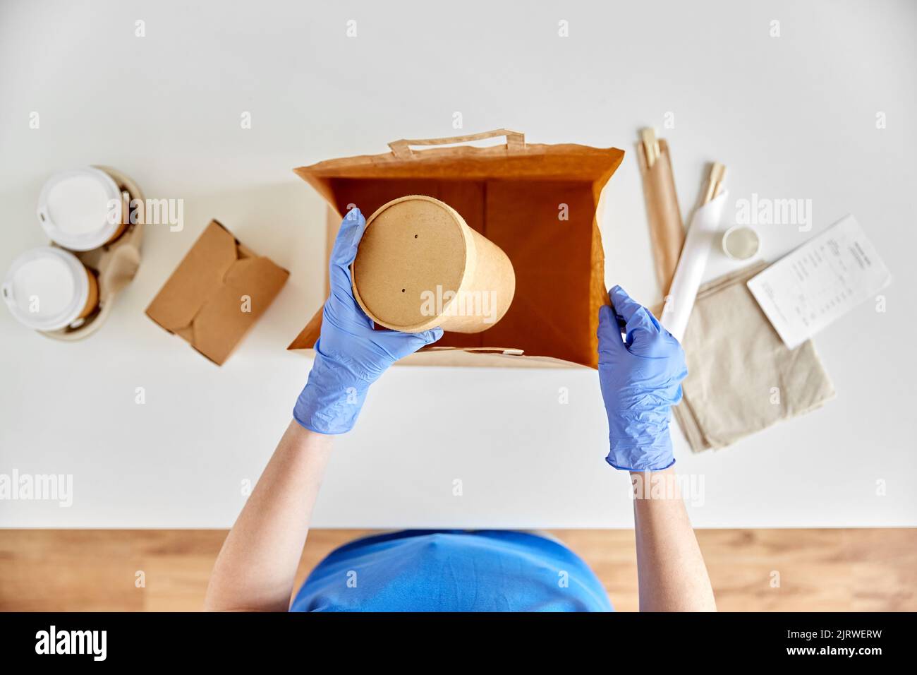 delivery woman in gloves packing food and drinks Stock Photo - Alamy