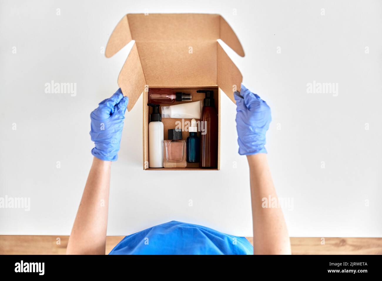Hands in gloves packing parcel hi-res stock photography and images - Alamy