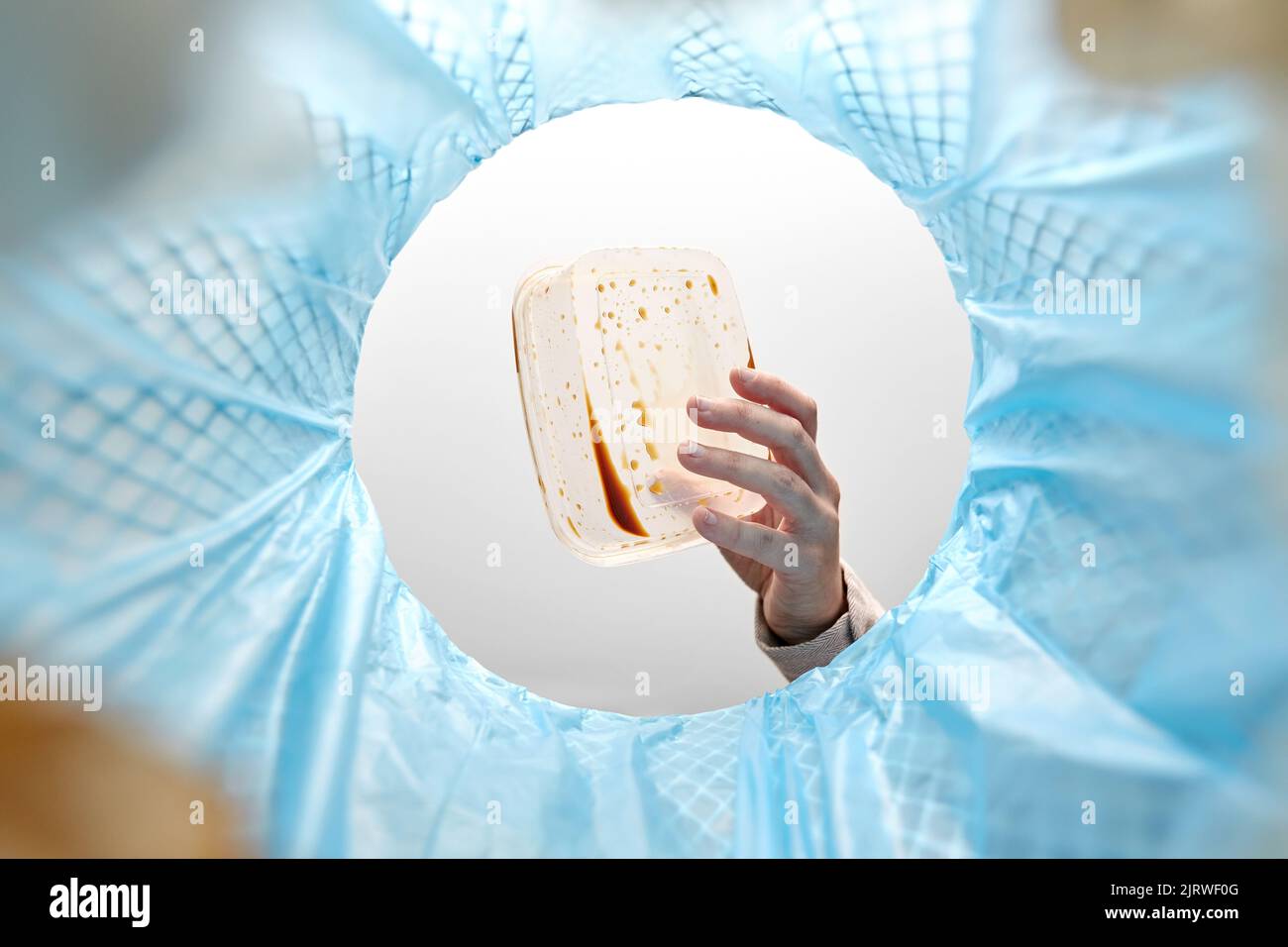 hand throwing plastic container into trash can Stock Photo Alamy