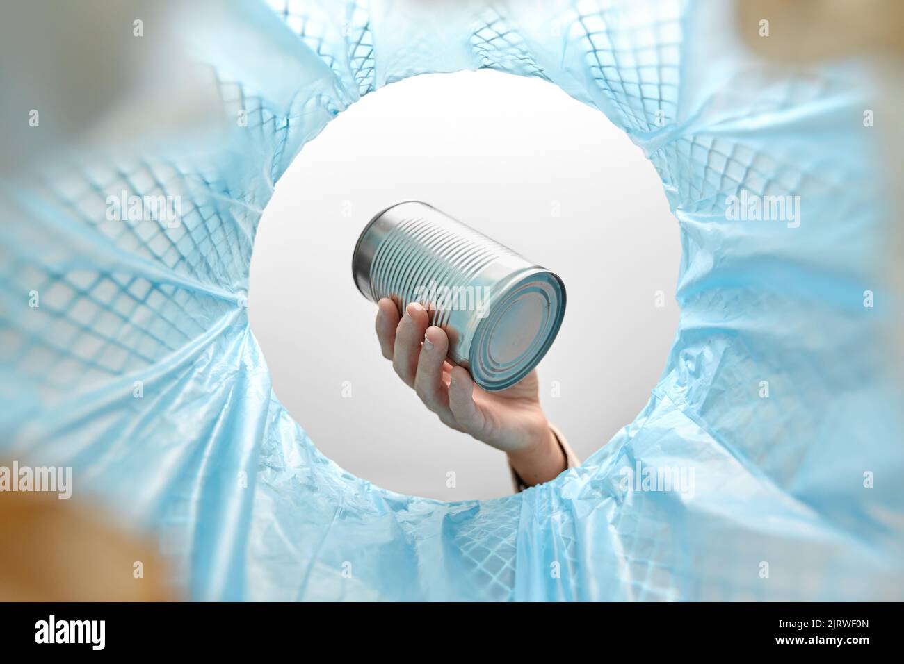 hand throwing tin can into rubbish bin Stock Photo Alamy
