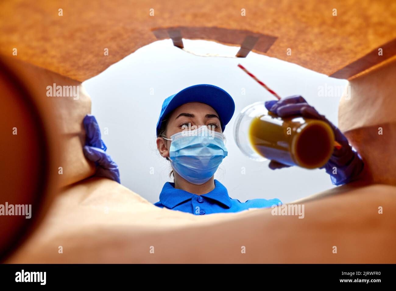 delivery girl in gloves and mask with food in bag Stock Photo - Alamy