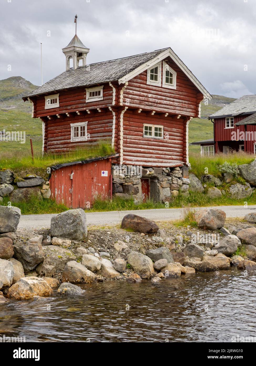 Traditional old two-storey wooden cabin with belfry at Eidsbugarden in the Jotunheimen National Park Norway Stock Photo
