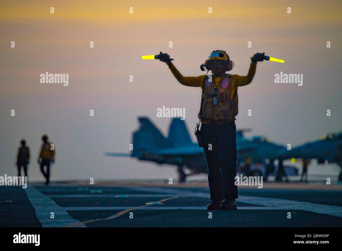 Palma, Spain. 24th Aug, 2022. U.S. Navy Aviation Boatswain Mate 3rd Class Nadia Chapel directs F/A-18F Super Hornet fighter aircraft for night operations on the flight deck of the Nimitz-class aircraft carrier USS Harry S. Truman, August 24, 2022 off the coast of Mallorca, Spain. Credit: MC3 Jack Hoppe/U.S. Navy/Alamy Live News Stock Photo