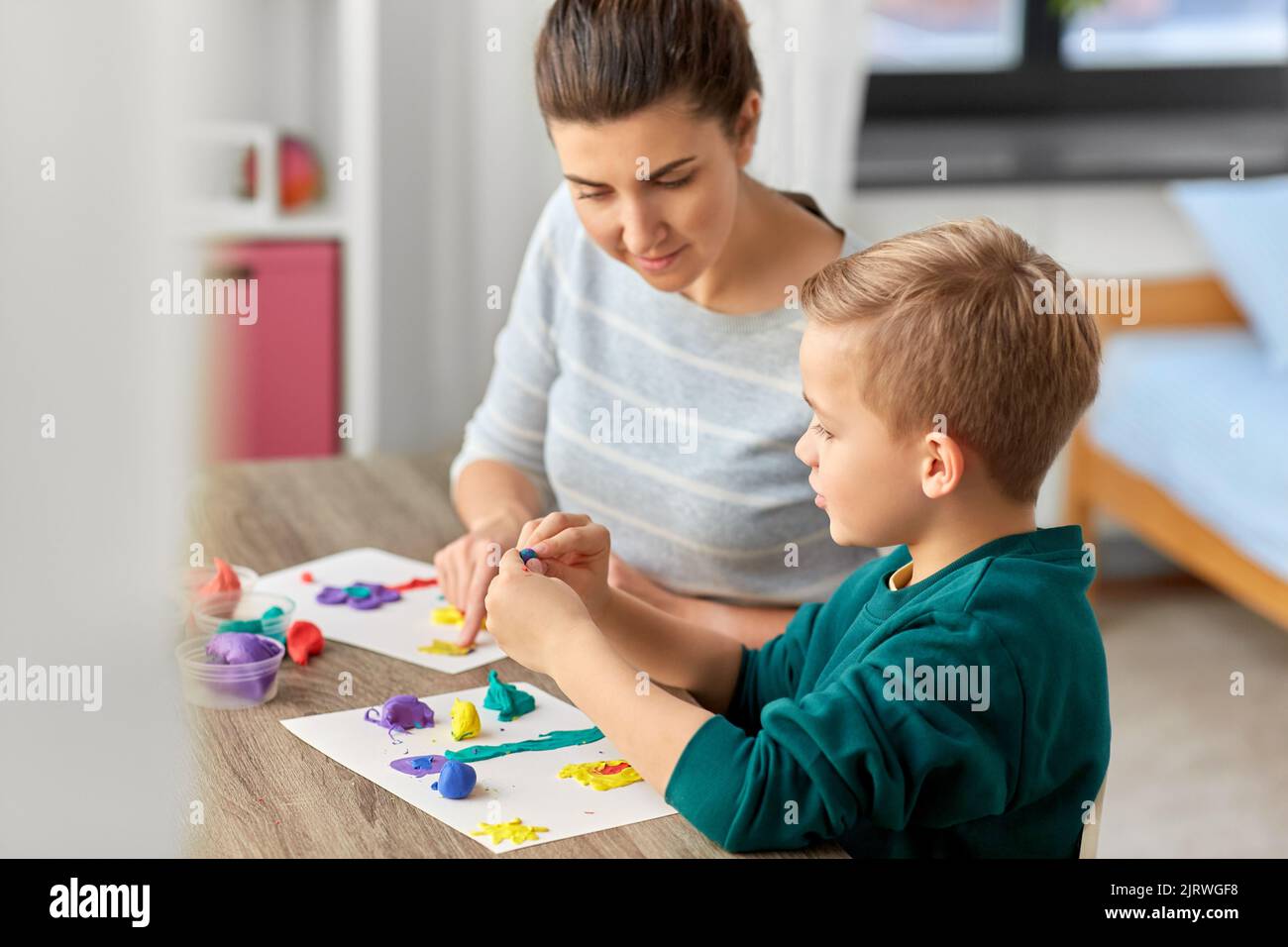 Small boy playing modeling clay hi-res stock photography and images - Alamy