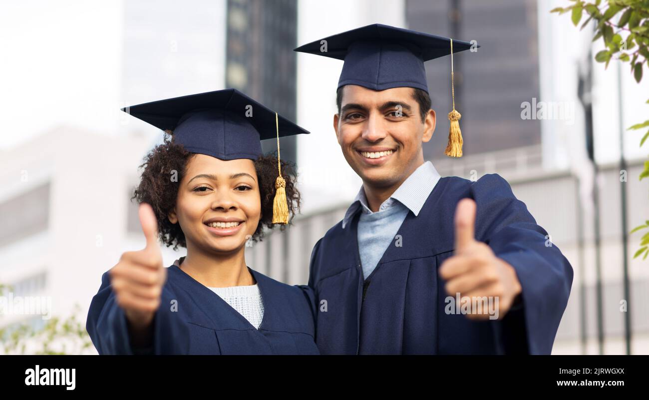 Happy Students Or Bachelors Showing Thumbs Up Stock Photo Alamy