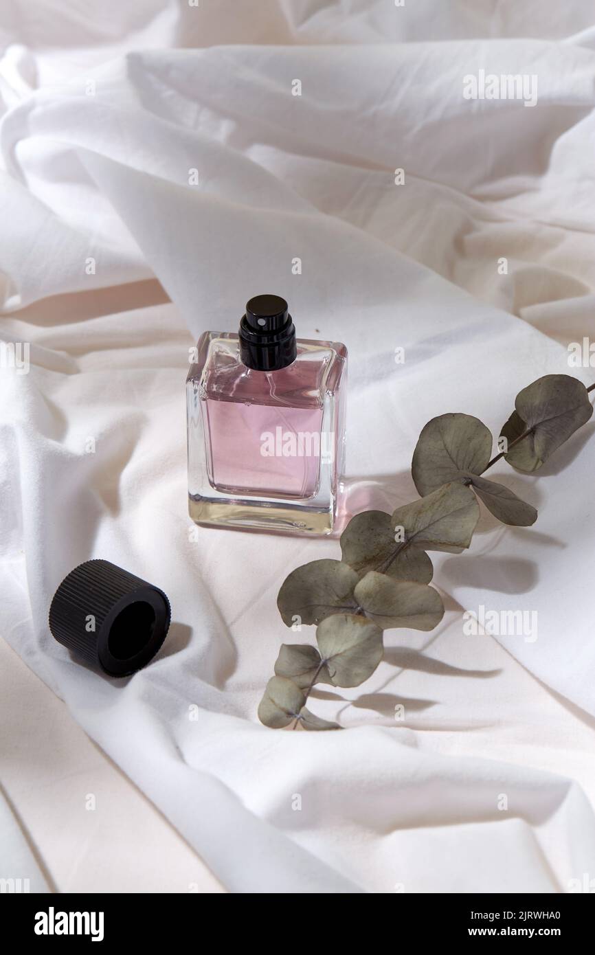 bottle of perfume and on white sheet Stock Photo Alamy