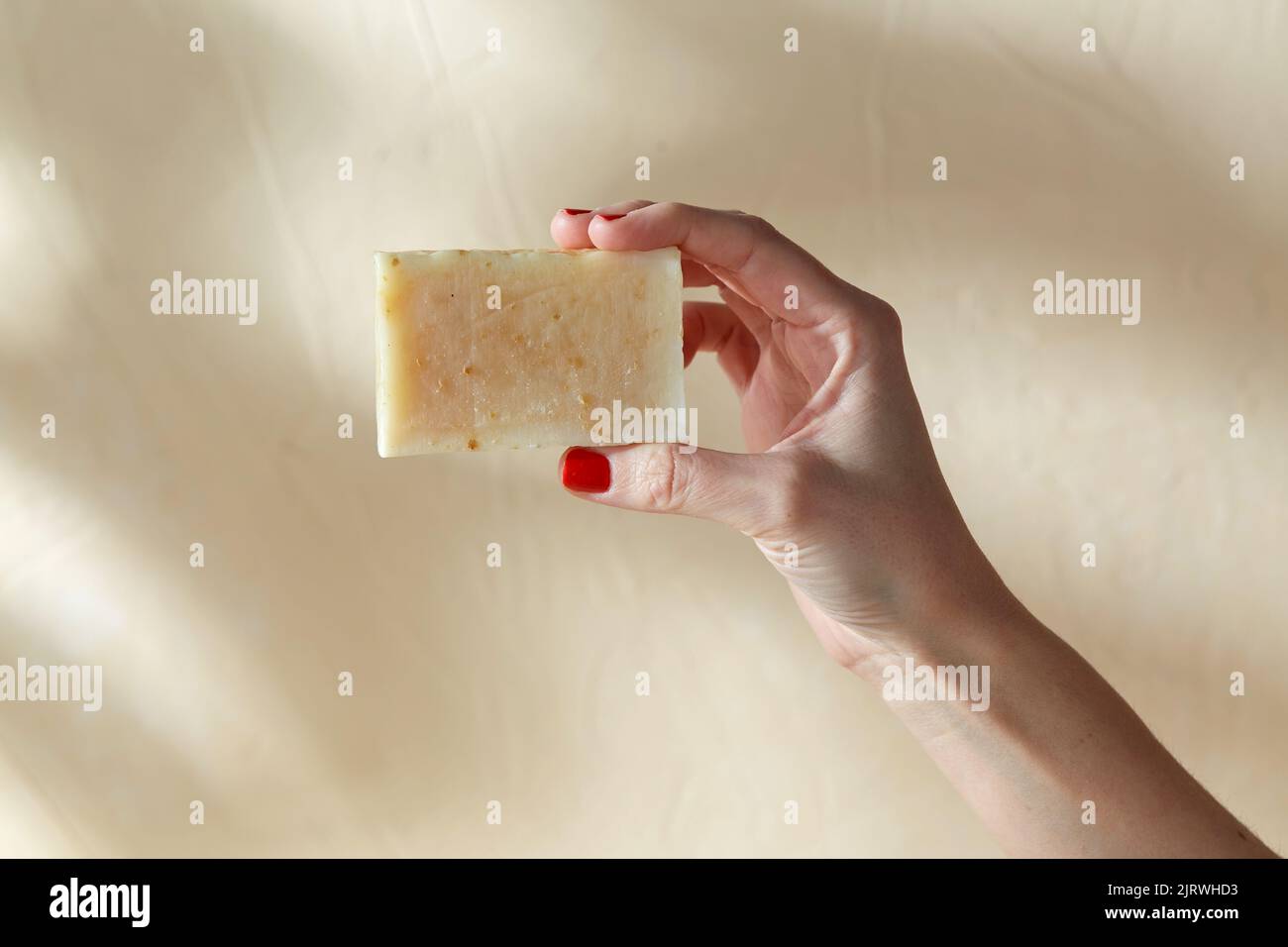 hand holding bar of craft soap on beige background Stock Photo Alamy