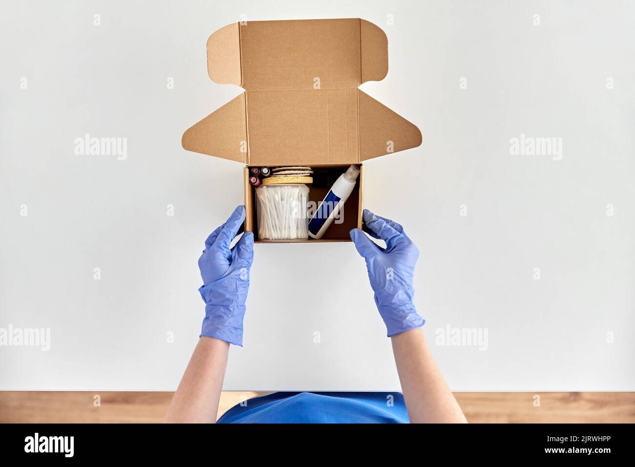 Hands in gloves packing parcel hi-res stock photography and images - Alamy
